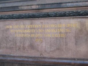 The inscription under the statue